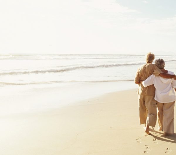 Elderly Couple on Beach Contemplating Home Safety