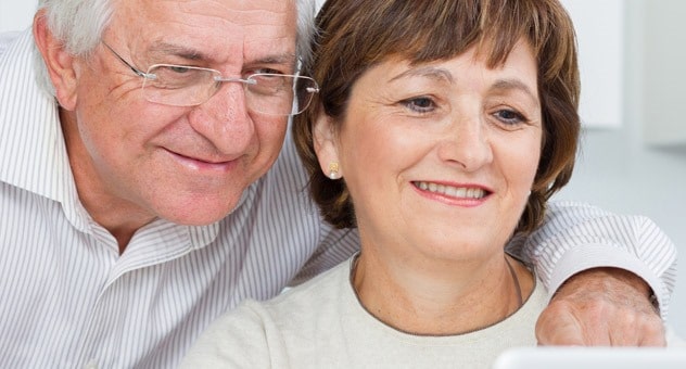 Grandpa looking over daughter shoulder at a Konnekt Videophone