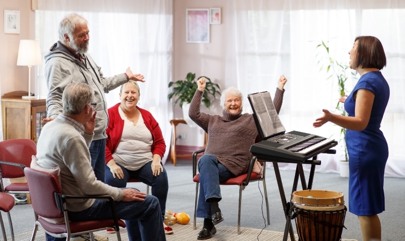 Prof Felicity Baker leads a small group in music therapy