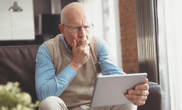 Gentleman struggling with small tablet or phone