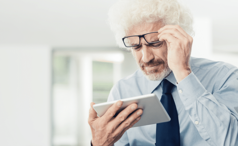 Older man struggles with phone